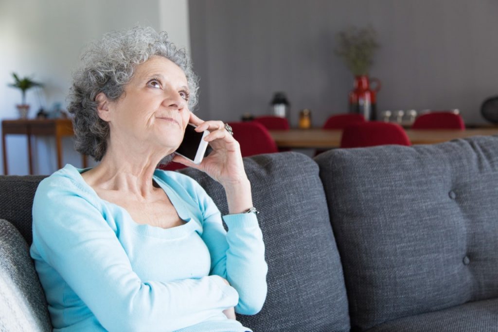 portrait-pensive-senior-woman-talking-mobile-phone